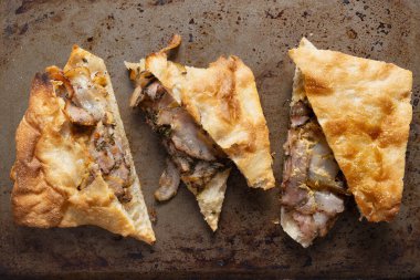 close up of italian roasted pork belly porchetta sandwich