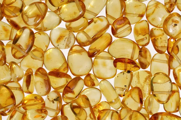 Yellow amber stones on a white background. — Stock Photo, Image