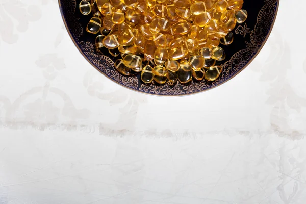 Amber in vintage plate. — Stock Photo, Image