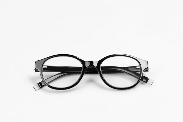 Os óculos pretos em um fundo claro . — Fotografia de Stock