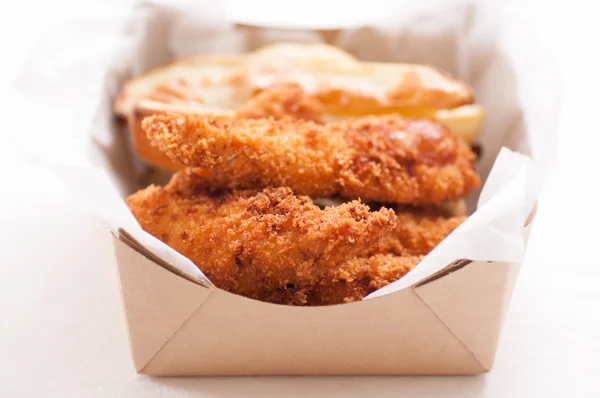 chicken strips and fries in a take out container