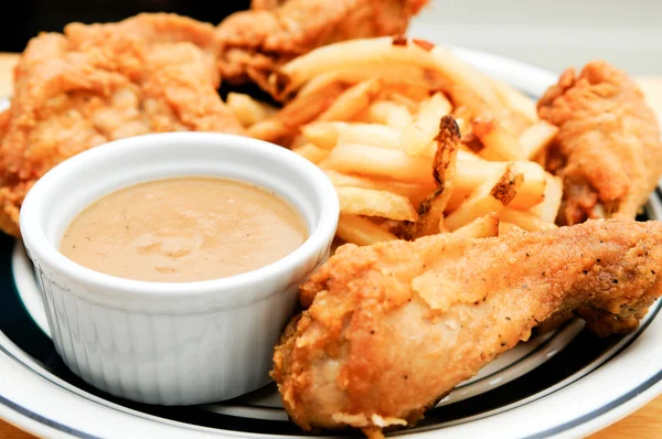 deep fried chicken with french fries and gravy