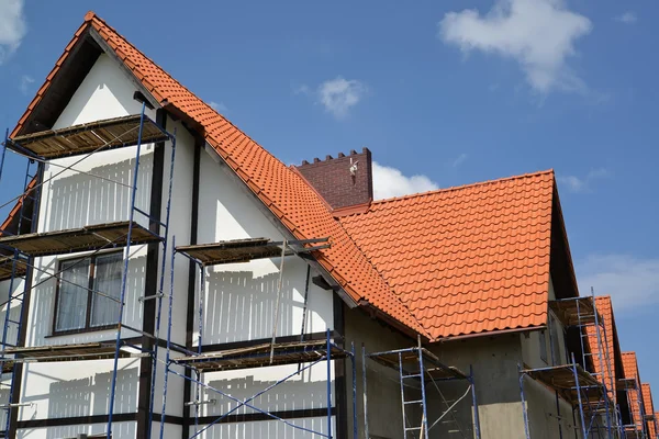 Construction of a house with a red tile roof Royalty Free Stock Photos