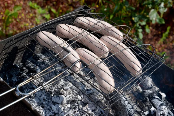 Frying of sausages on a brazier — Stock Photo, Image