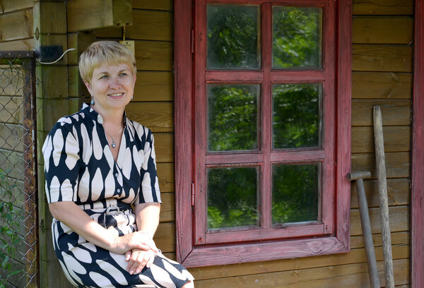 The woman of average years stays at home about rural