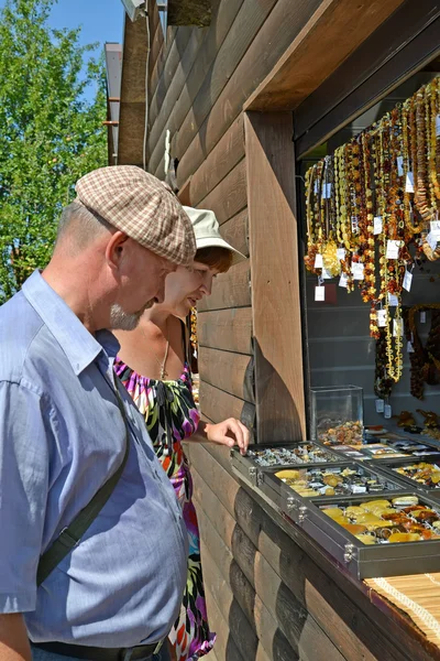 Le couple marié achète des bijoux en ambre dans un stand — Photo