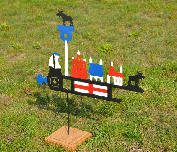The fishing Lithuanian weather vane costs on a grass — Stock Photo, Image