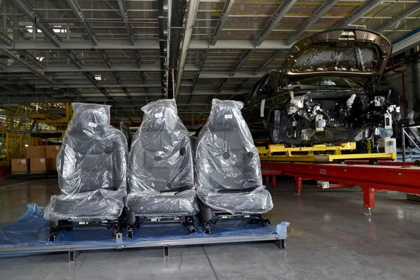 Automobile chairs in packing stand in assembly shop of automobil — Stock Photo, Image