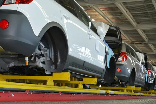 Les voitures se tiennent sur la ligne de convoyeur de l'atelier d'assemblage. Automobile pro Photos De Stock Libres De Droits