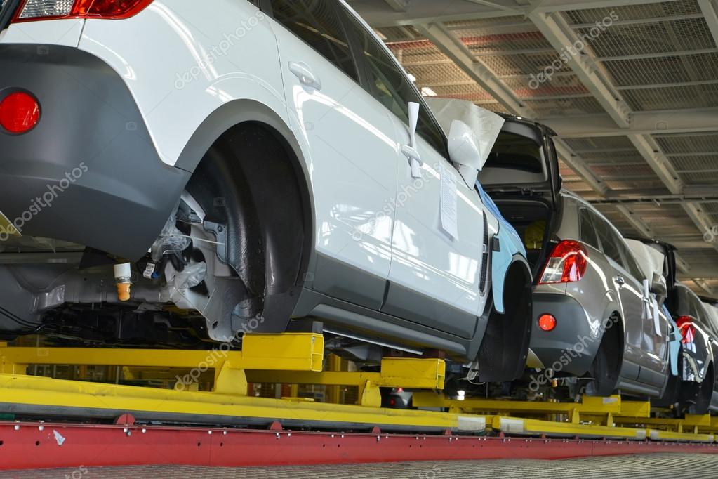 Cars stand on the conveyor line of assembly shop. Automobile pro Stock