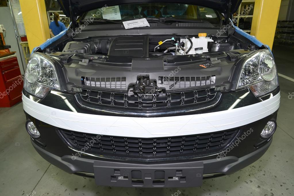 The car with an open cowl costs in assembly shop of automobile p