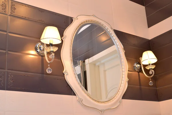 Mirror and two sconces in a bathroom. Modern classics with rococ — Stock Photo, Image