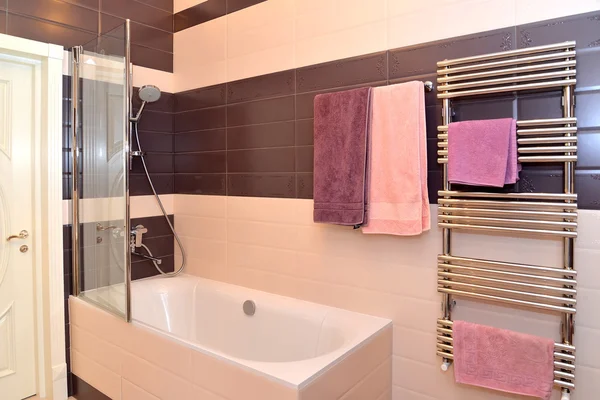 Interior do banheiro com as toalhas penduradas — Fotografia de Stock