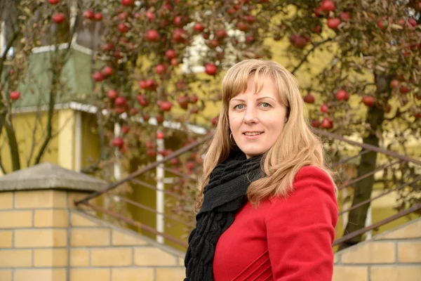 The young woman against an apple-tree with red apples — Stock Photo, Image