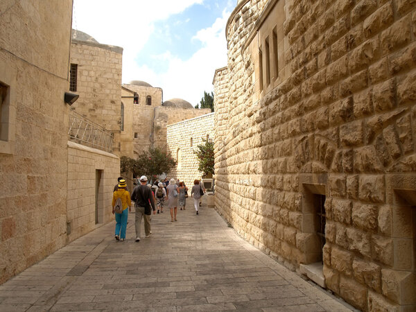 The group of tourists goes on the old city on the Mount Zion. Is
