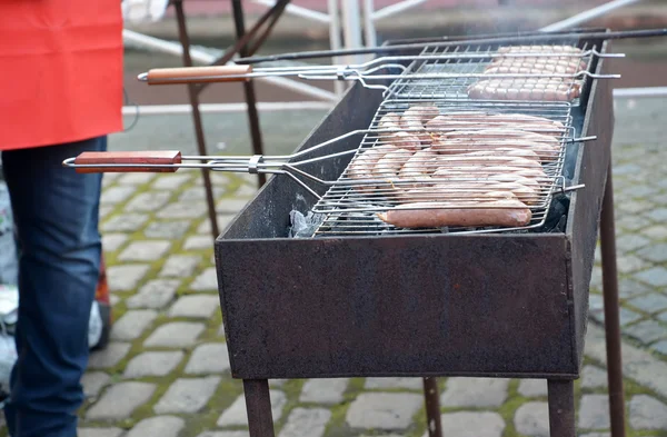 Frying of sausages on a street brazier — Stock Photo, Image