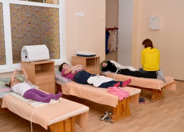Hasta çocukları tedavi bir magnetotherapy tarafından geçmek. Physiotherapeu