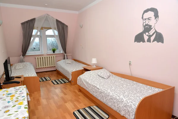 Triple hotel room with a portrait of the Russian writer A. P. Ch — Stock Photo, Image