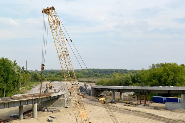 View of construction of a traffic intersection with a crane arro — Stock Photo, Image