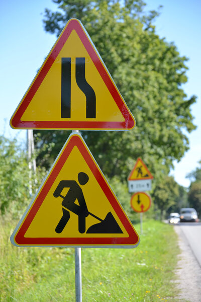 Road signs "Roadwork", "Narrowing of the road on the right" agai