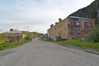 The street with the thrown houses in the settlement of Teriberka clipart