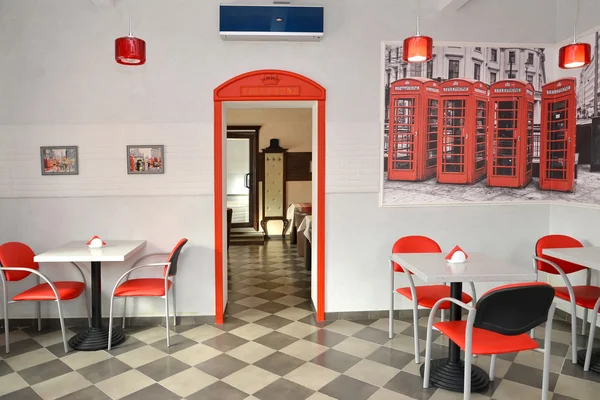 Interior of modern cafe in red and light tones. Stylization under the London landscape — Stock Photo, Image