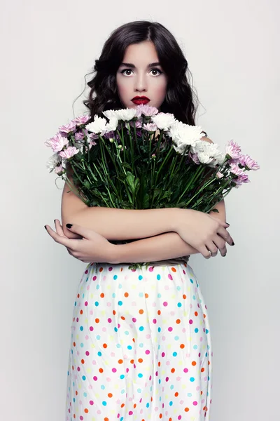 Glamorous portrait of brunette with a dress in peas. Stock Photo