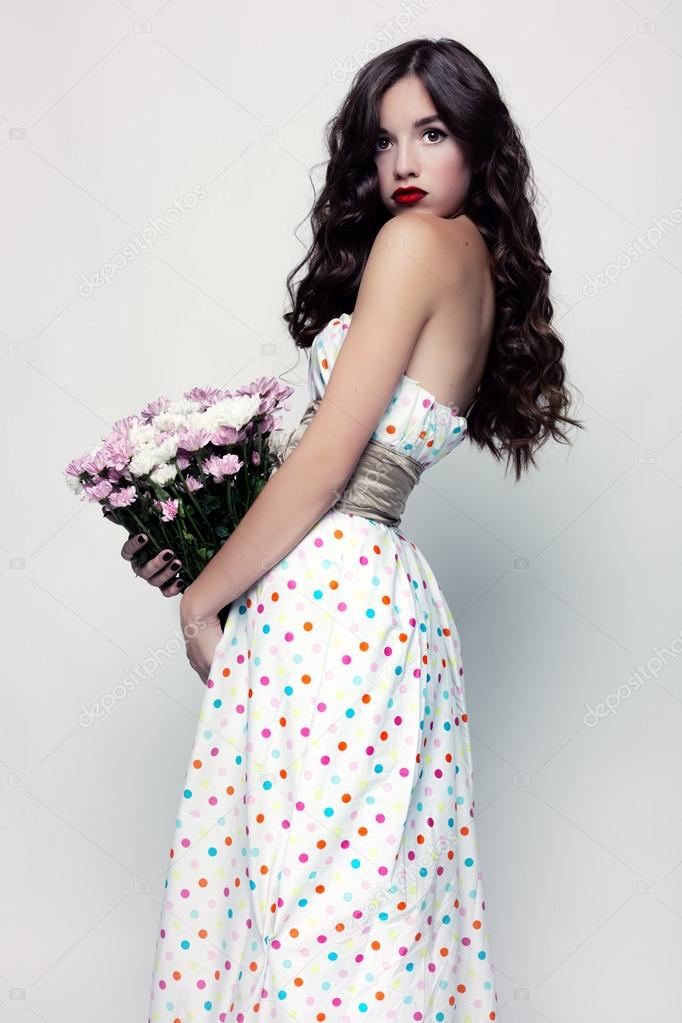 Glamorous portrait of brunette with a dress in peas.