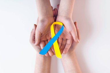 Dünya Down Sendromu Sendromu Günü 'ne yardım eden mavi sarı farkındalık kurdelesi. 21 Mart. Down sendromu olan hastalara ve Thorasic Outlet Sendromu olan hastalara destek artıyor.)