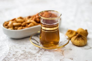 Tea with cashew and  figs clipart