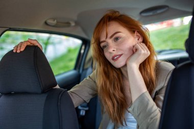 Düşünceli Kızıl Saçlı Kadın Araba Koltuğuna Eğiliyor, Meraklı Genç Yolcu Uzağa Bakıyor, Araç, Seyahat ve Keşif Konseptinde Zencefil Kızın Yaşam Tarzı Portresi.