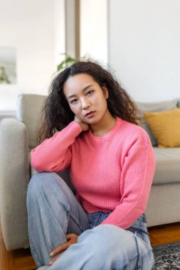 Portrait of beautiful young Asian woman looking at camera. Beautiful woman smiling at home.