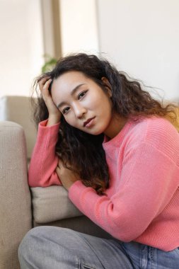 Portrait of beautiful young Asian woman looking at camera. Beautiful woman smiling at home.