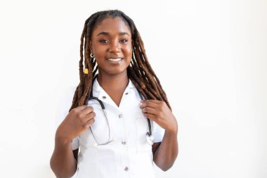 Confident smiling doctor posing and looking at camera with stethoscope in her hands. Friendly African American female doctor smiling. Doctor with stethoscope around her neck
