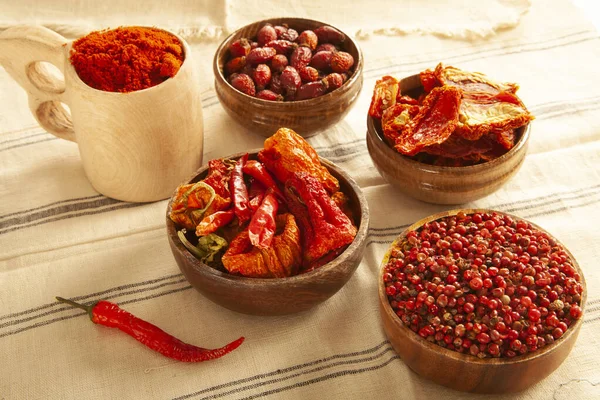 Red colored food. Dried healthy food spices. Dried tomatoes, dried peppers, rosehips, red pepper seeds, red pepper.
