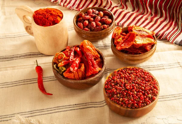 Red colored food. Dried healthy food spices. Dried tomatoes, dried peppers, rosehips, red pepper seeds, red pepper.