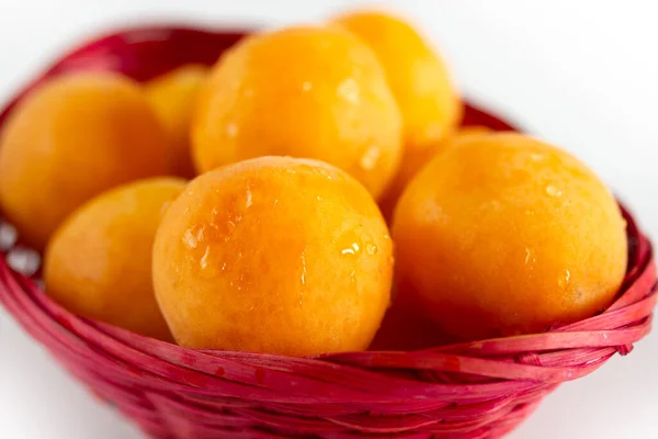 organic apricots in a pink basket