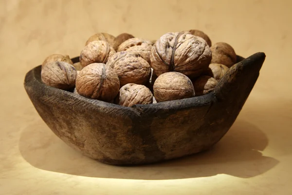 Walnut and antique wooden plate — Stock Photo, Image