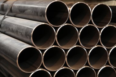 The steel pipes manufactured in the factory clipart
