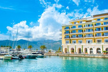 Tivat, Karadağ - 28 Haziran 2021: Porto Karadağ 'daki yat marinasının deniz kenarındaki konutları ve güzel gezinti alanlarıyla gün batımı manzarası