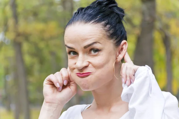 Funny brunette in autumn park — Stock Photo, Image