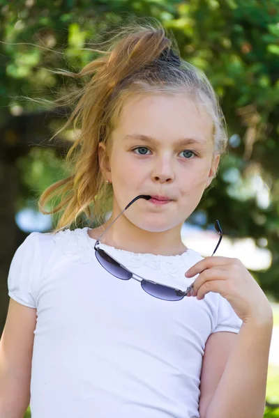 Cute girl playing with sunglasses — Stock Photo, Image