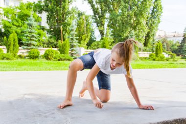 Sevimli kız tebeşir asfaltta çizer.