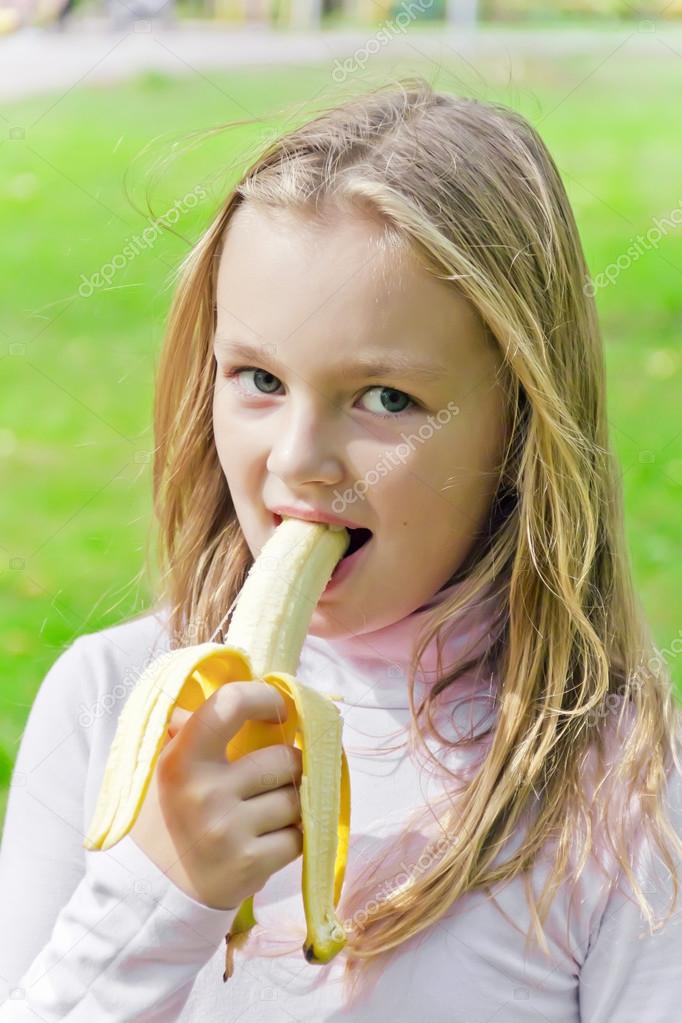 Girl are eating banana — Stock Photo © julialine 70022793