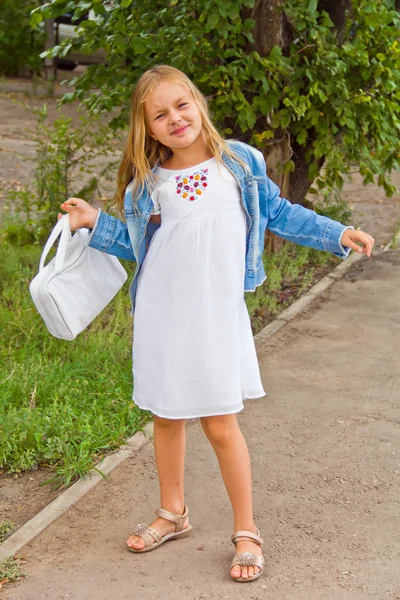 Cute girl playing with white bag — Stock Photo, Image