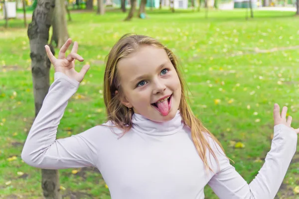 Young girl sticking out her tongue Stock Photos, Royalty Free Young
