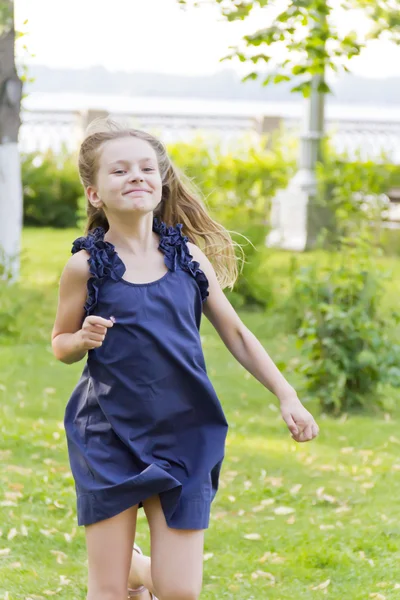 Girl is running in blue dress — Stock Photo, Image