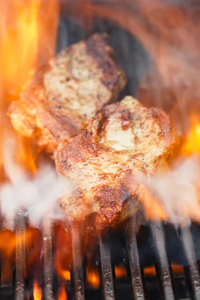 Pork steak on bbq grill with flame — Stock Photo, Image
