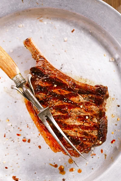 Beef steak on vintage metal plate — Stock Photo, Image