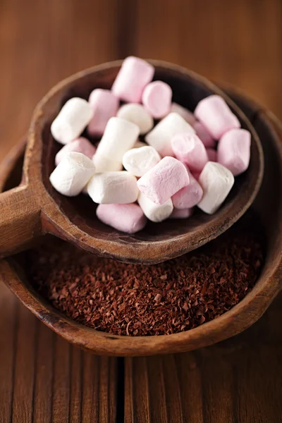 Grated chocolate and marshmallow candies in old spoon — Stock Photo, Image